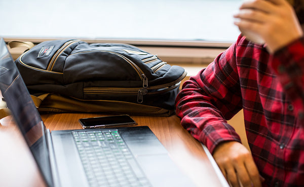 A person at a table in a ferry with the Guide's Edition Synapse 25.